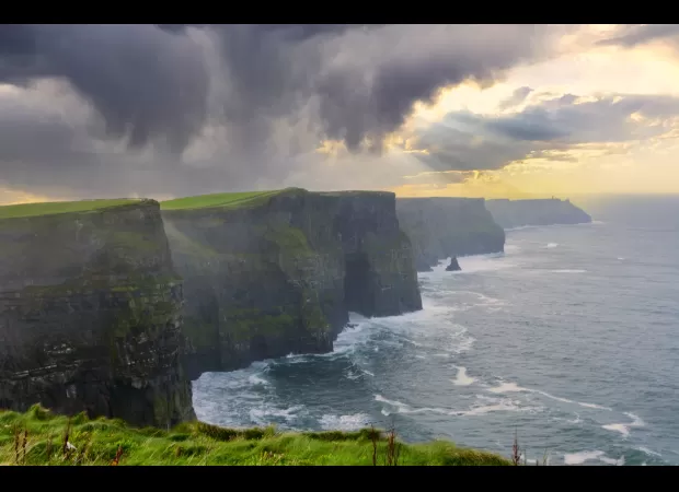 A body was found during the search for a 12-year-old boy who fell from a 702ft cliff into the water.