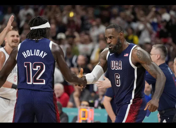 The American men's basketball team easily defeats Serbia 110-84 in their first game at the Paris Olympics.