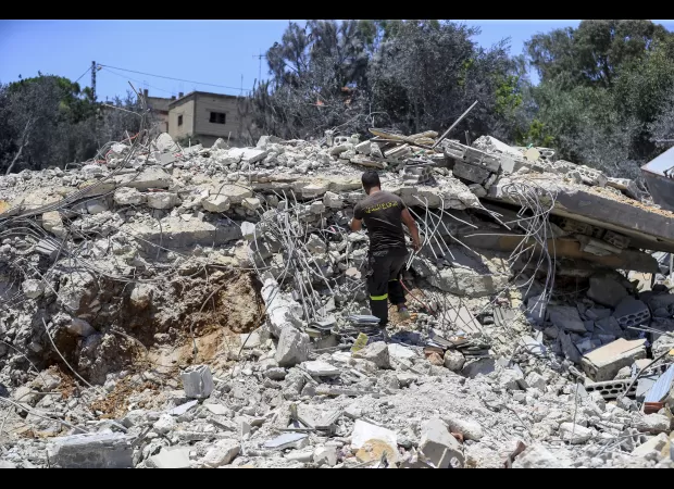 Possible paraphrase:
The looming Middle East conflict that nobody desires may finally ignite.