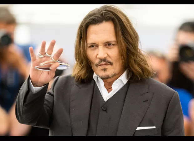 Johnny Depp honors co-star's enthusiasm for life after surfer's death in shark attack during filming of Pirates of the Caribbean.