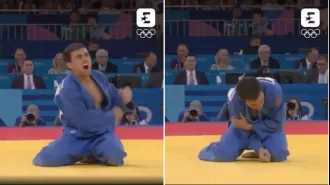 An Olympic athlete shouts in pain after sustaining a bizarre injury during their medal celebration.