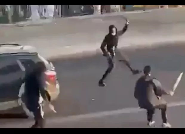 Police monitoring machete fight at beach town amusement park.