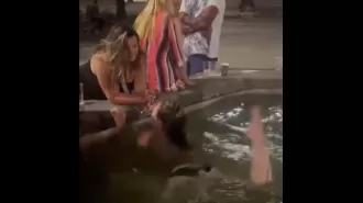 A tourist bathing topless in Florence fountain angers locals.