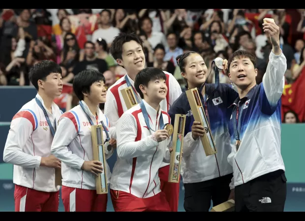 A striking podium selfie with athletes from North and South Korea explained.