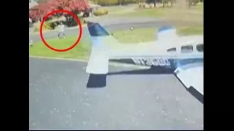 A plane crashes onto a golf course and almost hits a golfer in a wild incident.