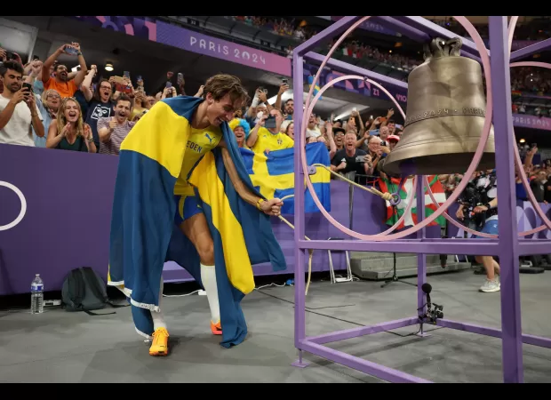 BBC reporter Gabby Logan questions whether the Olympic bell will be able to ring due to its size and weight.