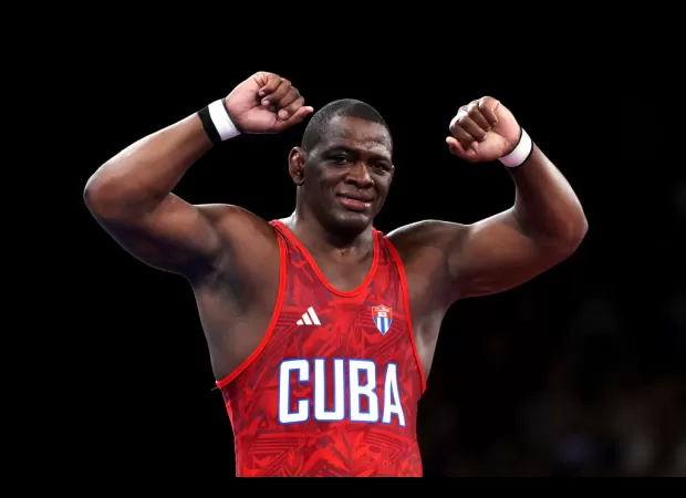WWE icon congratulates Olympic wrestler on winning record-breaking gold medal.