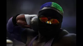 Raven Saunders, a USA athlete, is wearing a full face mask and glasses during the Olympics.