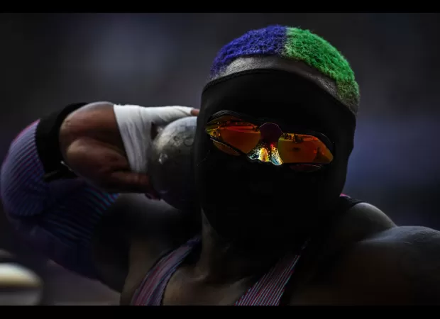 Raven Saunders, a USA athlete, is wearing a full face mask and glasses during the Olympics.