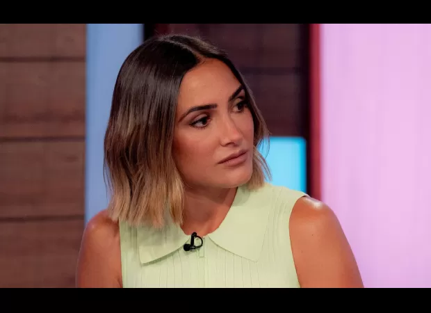 TV host's expression changes as she accuses colleague of giving a negative compliment.