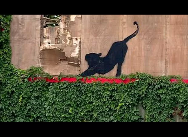 Is this the 6th Banksy in a week? Cat seen stretching on London billboard.