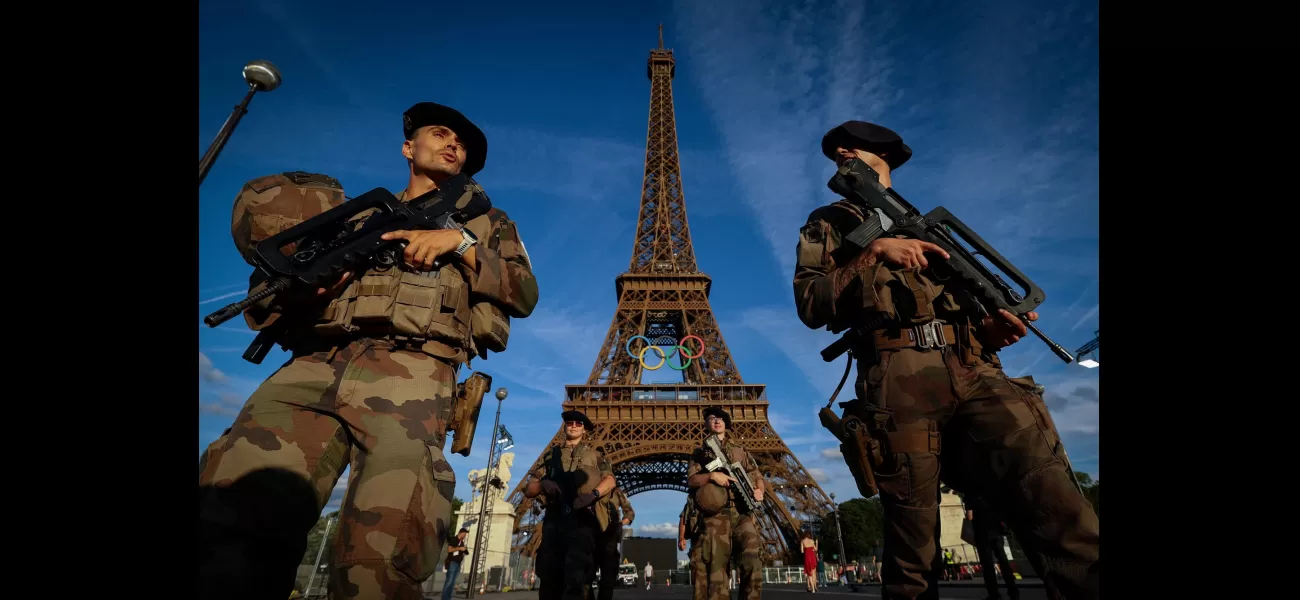 Police forcibly remove person from top of Eiffel Tower.