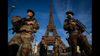 Police forcibly remove person from top of Eiffel Tower.