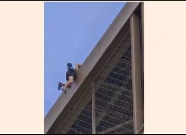 A person climbing Eiffel Tower causes evacuation before closing ceremony.