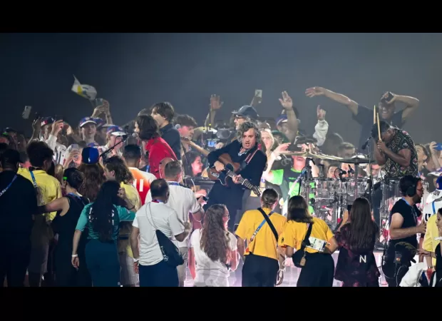 The stadium announcer mistakenly tells Olympians to leave the stage during the closing ceremony, causing an awkward moment.