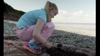 A girl discovered dinosaur footprints while taking a stroll on the beach.