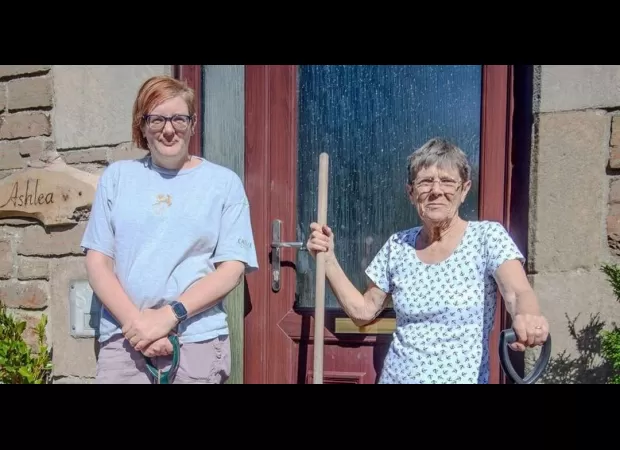 An elderly woman, 75, fixes potholes outside her home on her own initiative.