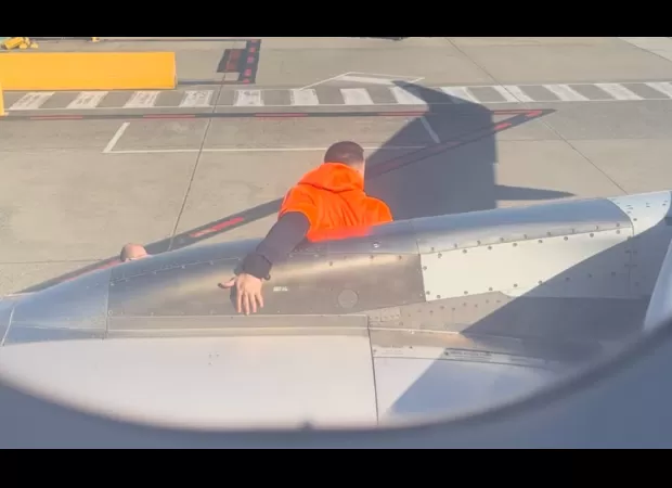 A passenger was taken into custody for opening the emergency exit during a Jetstar flight.