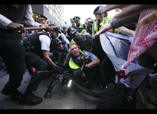 Police arrest 50+ at Chicago protest with large law enforcement presence.