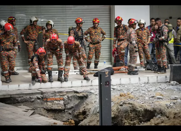 Woman falls into deep hole in Malaysia after pavement collapse.