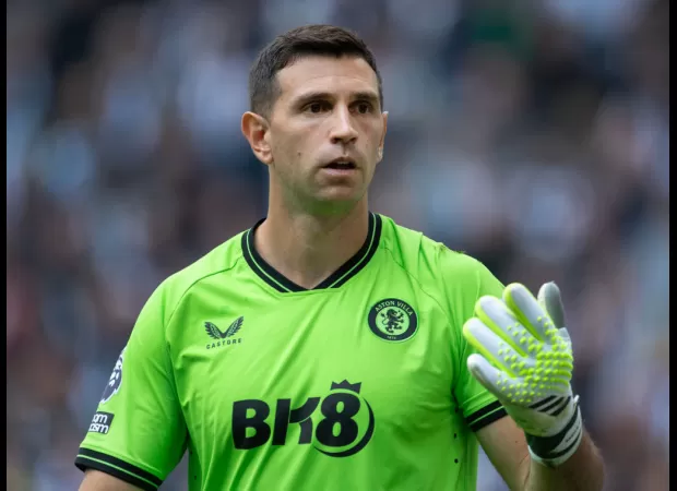 Aston Villa's goalkeeper, Emiliano Martinez, encourages an Arsenal player to move on and suggests a specific team to join.