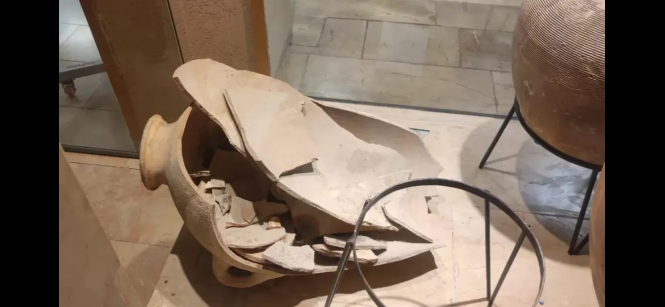 A child unintentionally breaks an ancient pitcher at a museum.