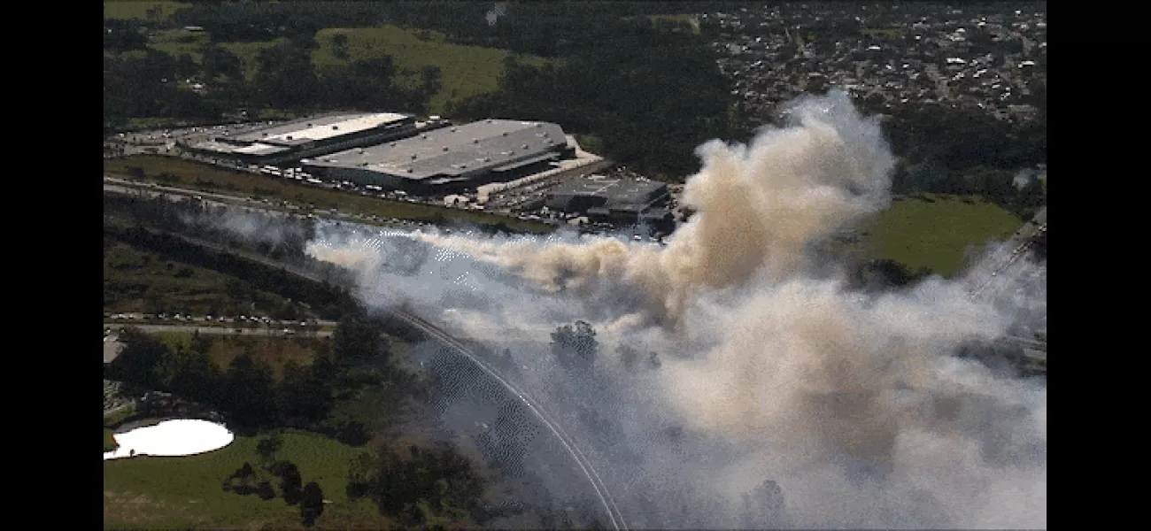 A grassfire in Sydney's south west has resulted in road closures and poses a threat to nearby homes.