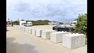 Controversy over parking in coastal town as owner puts up concrete barriers.