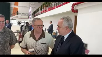 PM tells reporter to relax after being caught on camera talking privately with American representative.