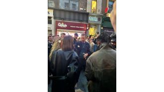 Coldplay surprises fans with unconventional 'barefoot' street performance of their hit song, repeated 5 times.