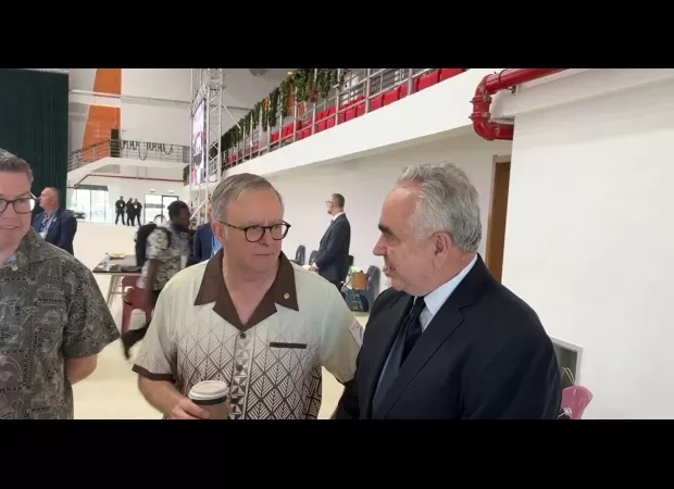 PM tells reporter to relax after being caught on camera talking privately with American representative.