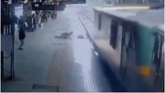 A woman hit by a fast train was rescued by a cop just in time.