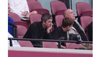Noel Gallagher takes a break from chaotic Oasis ticket sales to spend time with his son.