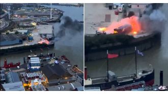A massive fire occurs near the O2 due to explosions during filming.