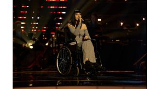 A woman in a wheelchair wows The Voice judges with a moving performance.