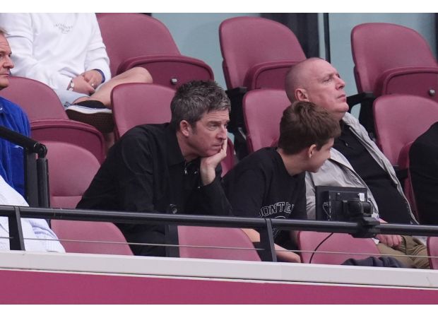 Noel Gallagher takes a break from chaotic Oasis ticket sales to spend time with his son.