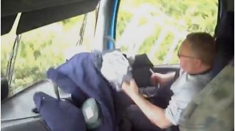 A truck driver using phone crashes into family's car on busy street.