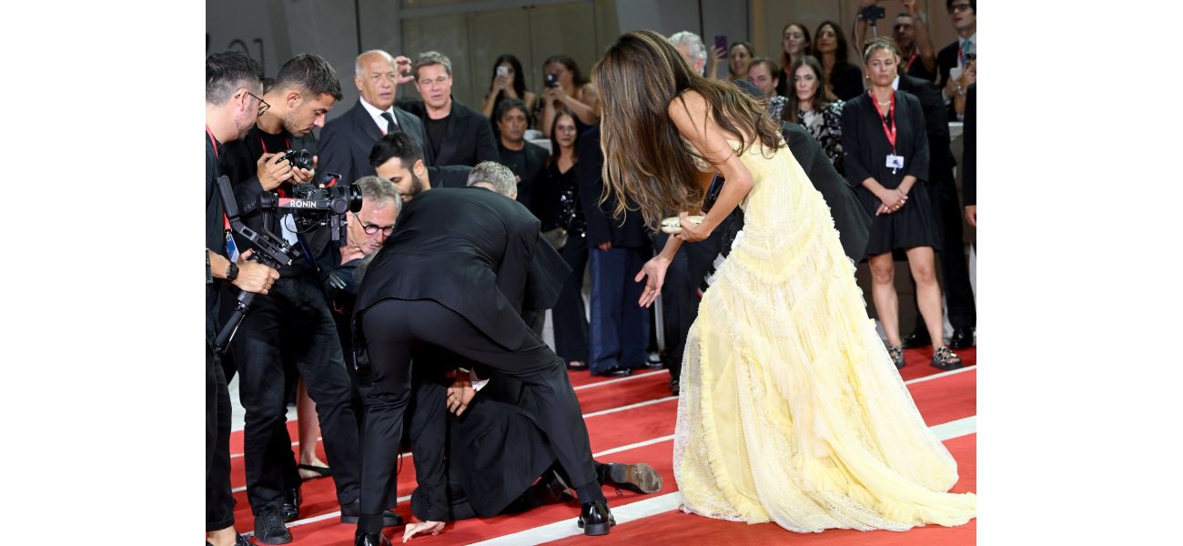 Hollywood star George Clooney saves the day following mishap at Venice film festival premiere.