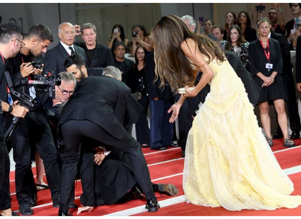 Hollywood star George Clooney saves the day following mishap at Venice film festival premiere.