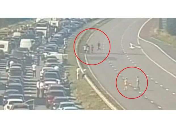 Drivers play soccer while stuck in long traffic jam.