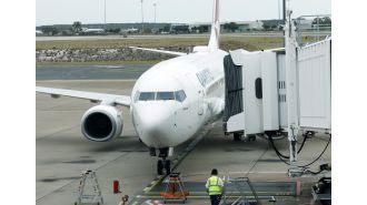 Air traffic controller caught sleeping while on duty under a blanket.
