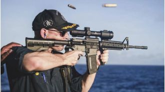 Navy dismisses commander for photo of rifle with wrong scope orientation.