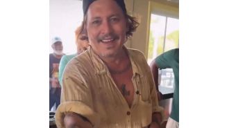 Johnny Depp shows off his new white teeth after previously suffering from severe tooth decay.