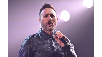 Former member of 2000s boyband unveils stunning physical transformation resembling a Greek god at recent event, shedding significant weight.