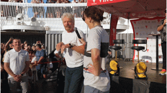 Raygun teaches Branson breakdancing on Virgin cruise.
