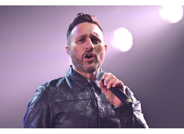 Former member of 2000s boyband unveils stunning physical transformation resembling a Greek god at recent event, shedding significant weight.