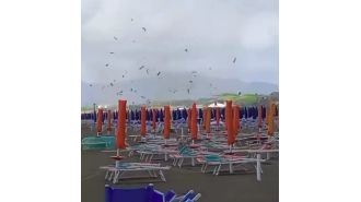 A sudden tornado on an Italian beach caused sunbeds and parasols to be thrown into the air.
