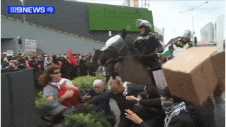 Protests turn violent as mounted police clash with demonstrators in Melbourne.