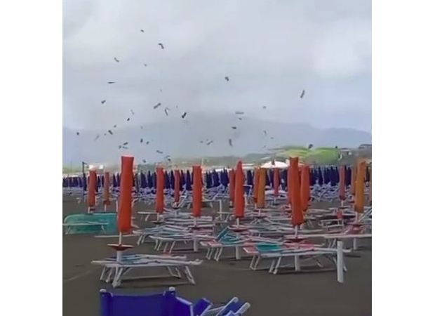 A sudden tornado on an Italian beach caused sunbeds and parasols to be thrown into the air.