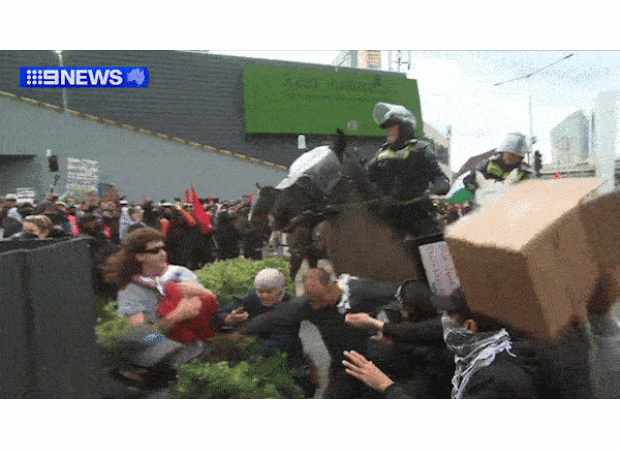 Protests turn violent as mounted police clash with demonstrators in Melbourne.